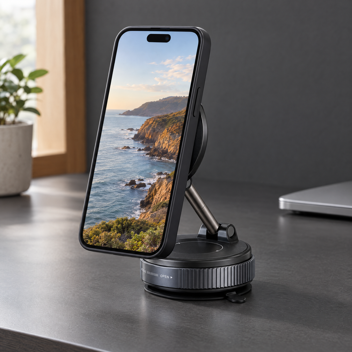 Magnetic phone holder supporting an upright smartphone on a smooth desk